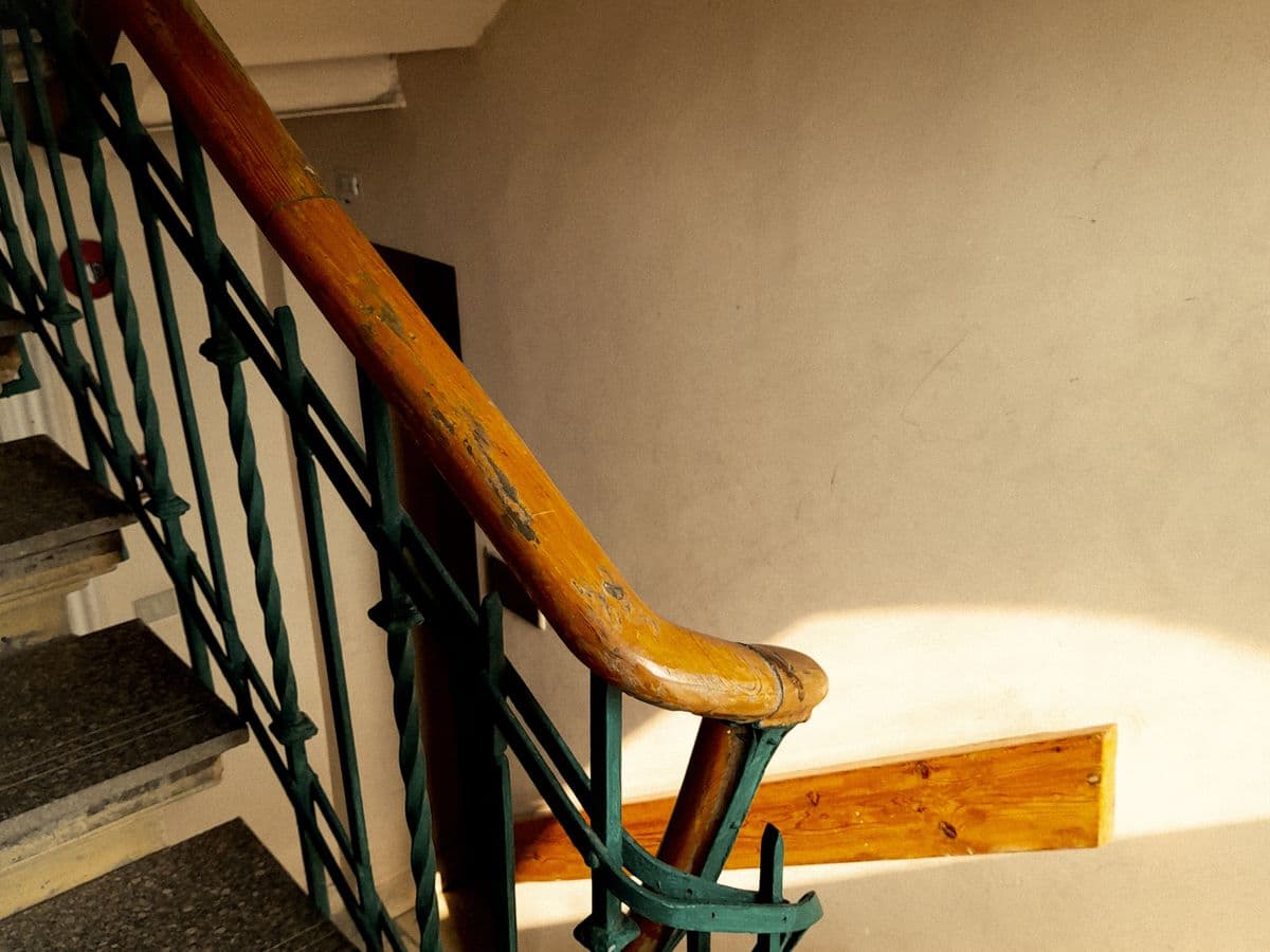 A sunlit staircase in the shared entrance of an apartment building