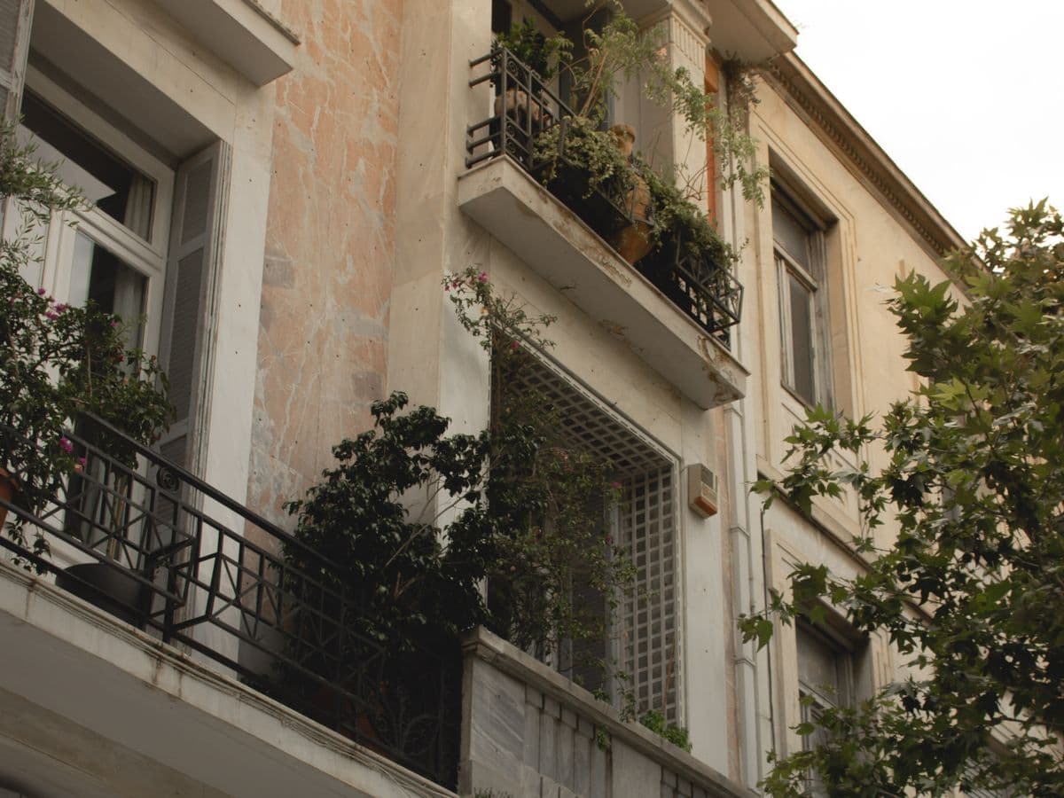 Balconies full of plants on an apartment building in Athens